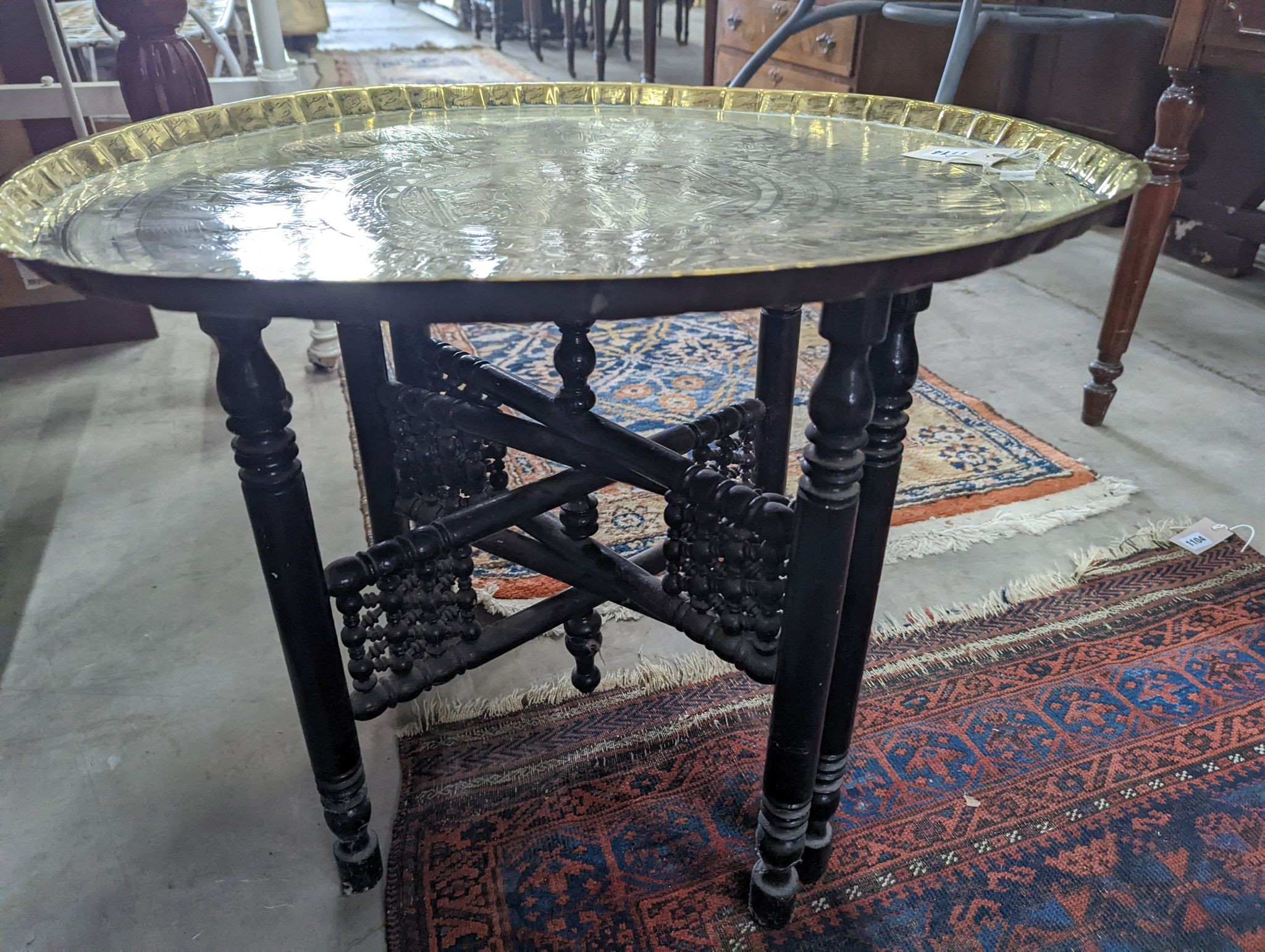 An Egyptian circular brass tray top occasional table, diameter 62cm, height 52cm